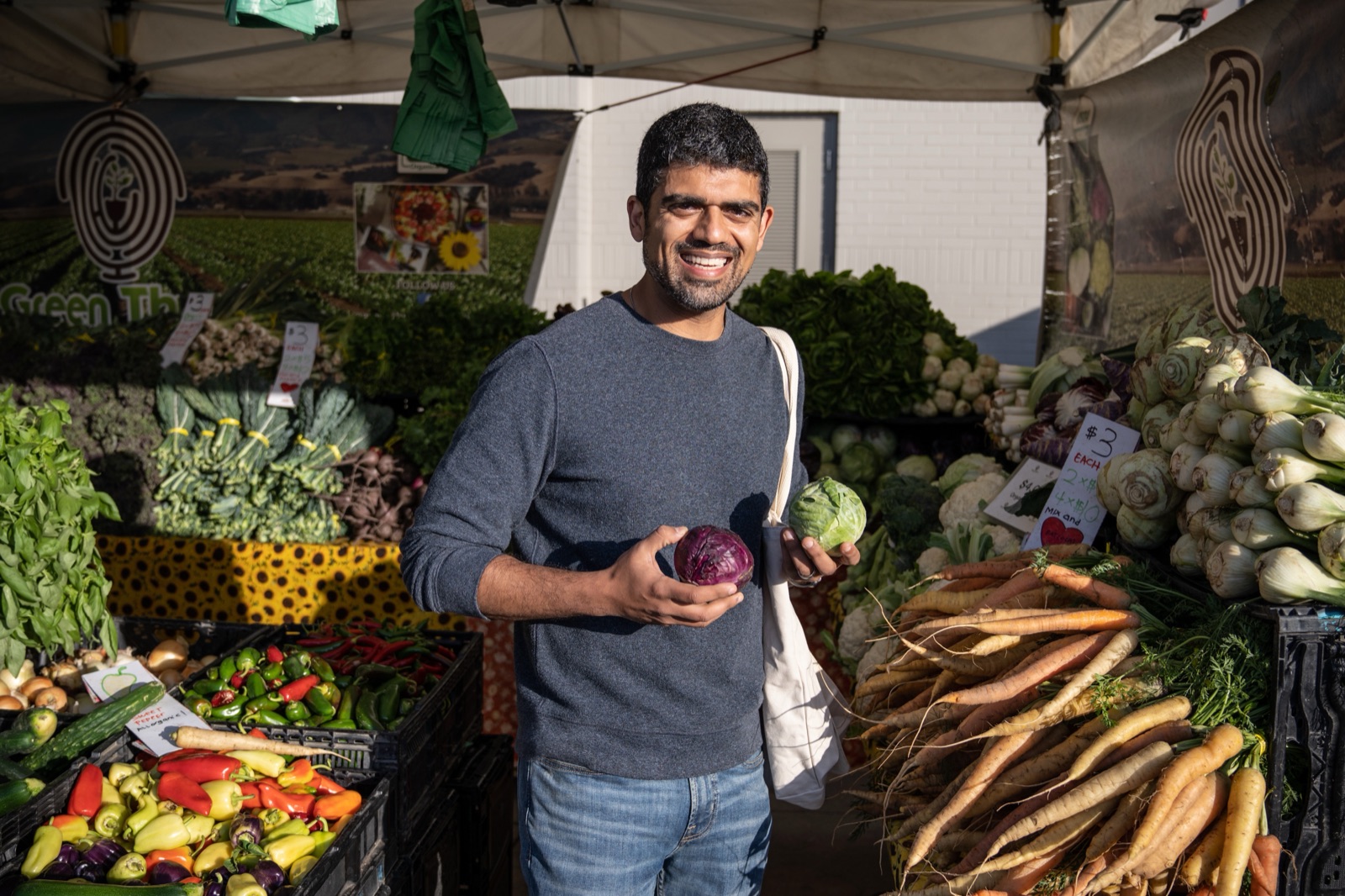 Dr. Rak at the farmers market holding a red cabbage